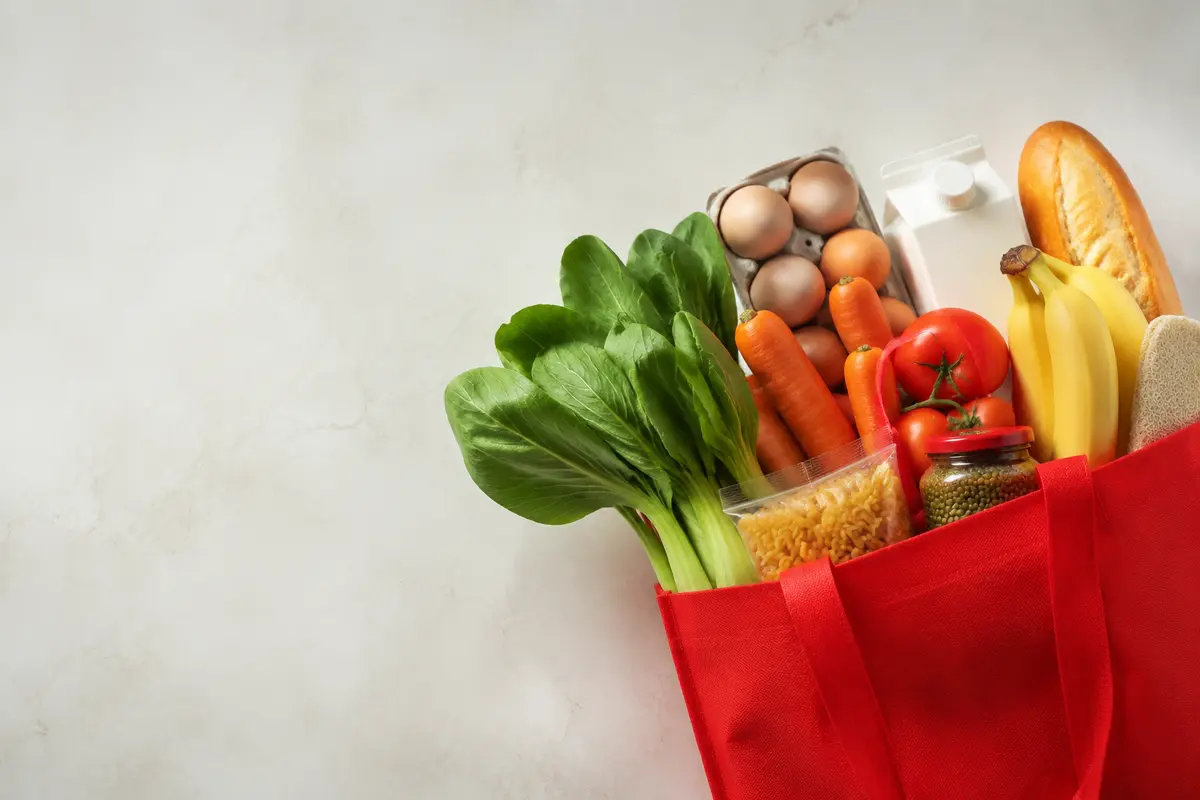 Fresh groceries in a red shopping bag
